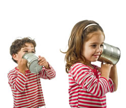 Two kids with a tin can telephone